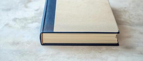 Closed Hardcover Book On White Surface photo