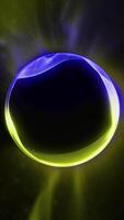 A virtual yellow-blue ball glows in space, plays with its edges, shimmering with waves of energy. video