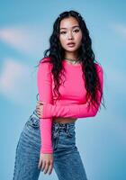 A young woman in a pink top and jeans photo