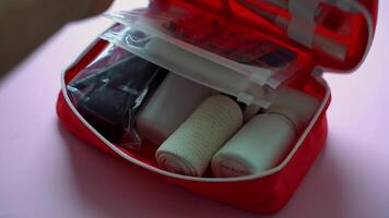 This portable red first aid kit is designed for emergencies, containing essential supplies like bandages, antiseptics, and tools for quick responses to unexpected injuries video
