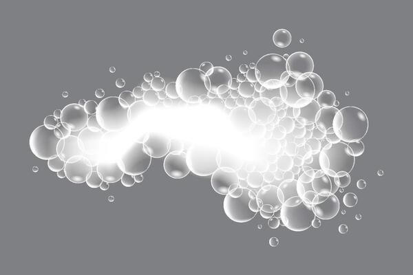 Soap bubbles, displaying unique designs, gracefully float on a plain gray surface