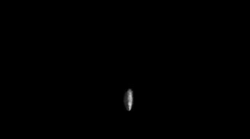 Small glowing white object floating in the dark with a mysterious atmosphere. Abstract night concept video