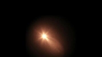 Glowing golden light burst with soft diffusion in dark space creating a warm atmospheric effect. Abstract illumination concept video