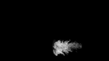 Dense white smoke puff spreading horizontally in darkness on black background. Atmospheric effect concept video
