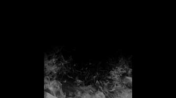 Soft white smoke moving on a black background with transparent fog effect. Visual effect concept video