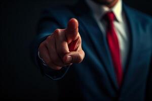 A man in a suit pointing at something photo