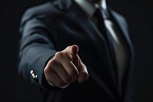 A man in a suit pointing at something photo