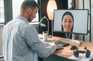 Retouching portrait of woman.. Designer is sitting by the computer and using graphics tablet with stylus photo