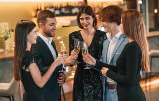 Conception ,of celebrating ,event. Group of people in elegant clothes are in the restaurant photo