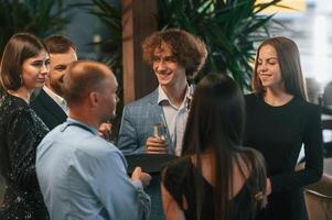 Conception of celebrating ,event. Group of people in elegant clothes are in the restaurant photo