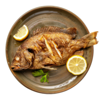 Fried fish on a plate with lemon slices and parsley png