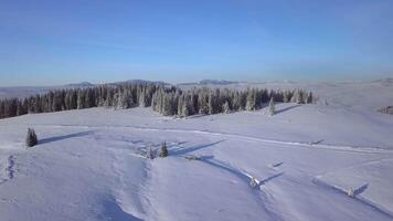 Flight over mountain range and forest in winter. Aerial view of Beautiful landscape of nature. 4K video