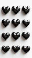 Display of glossy black heart shapes arranged in a grid on a light background for decoration or design purposes photo