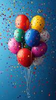 Colorful balloons surrounded by confetti create a festive atmosphere at a celebration or party photo
