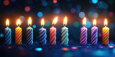 Colorful candles glowing softly on a dark background during a festive celebration photo