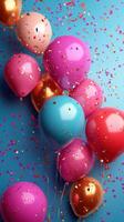 Colorful balloons with confetti floating against a bright blue background for a festive celebration photo