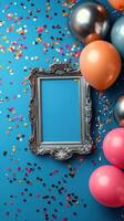 Colorful balloons and confetti surround an empty ornate frame against a vibrant blue background for a festive celebration photo