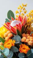 Vibrant floral arrangement featuring orange and yellow blossoms in a bright indoor setting photo