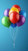 Colorful balloons floating against a bright blue background for celebration and decoration photo