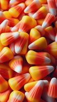 Colorful candy corn fills the frame, capturing the essence of autumn festivities and Halloween celebrations photo