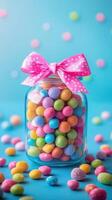 Colorful candy jar with bright candies and a pink bow against a blue backdrop photo