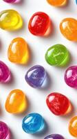 Colorful jelly candies arranged neatly with bright hues displayed on a white surface photo