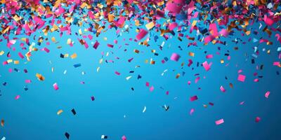 Bright confetti falling against a blue background during a festive celebration or party atmosphere photo
