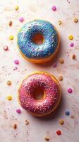 Colorful donuts with sprinkles surrounded by candy on a light background in a playful dessert display photo