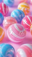 Colorful marble-like spheres scattered on a pink surface create a vibrant and playful atmosphere for artistic design photo