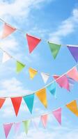 Colorful bunting flags flutter against a bright blue sky, creating a festive atmosphere for outdoor gatherings and celebrations photo