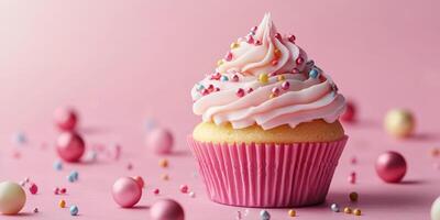 Delicious pink frosted cupcake with colorful sprinkles on a pastel pink background photo