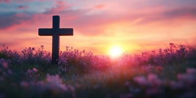 Beautiful sunset over a cross in a field adorned with flowers creates a serene and reflective atmosphere photo