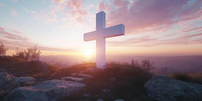 Sunset view of a white cross on a hilltop surrounded by nature and vibrant sky colors photo