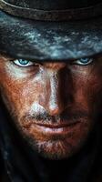 Intense close-up of a rugged cowboy with striking blue eyes under a dark hat against a dramatic backdrop photo