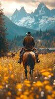 Rider explores vibrant wildflower fields under majestic mountains during golden hour in autumn photo