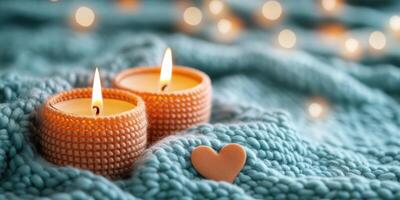 Cozy candles illuminate a soft knitted blanket with a heart accent in a warm setting photo
