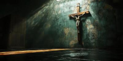Light filters through a dim room illuminating a wooden crucifix on the wall photo