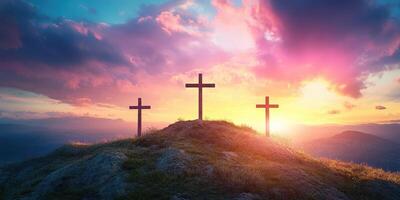 Beautiful sunrise over three crosses on a hill against a colorful sky in a peaceful landscape photo