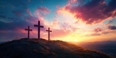 Sunset behind three crosses on a hilltop with colorful clouds in the sky photo