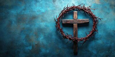 Cross with thorn crown displayed against a textured blue background in a spiritual setting photo