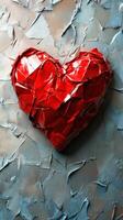Red heart sculpture made from crumpled metal on textured wall background showcasing love and art photo