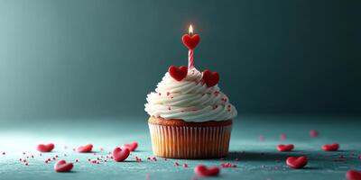 Cupcake decorated with heart shapes and a candle for a celebration in a cozy setting photo