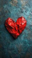 Crumpled red heart sculpture on a textured blue background showcasing artistic expression and emotion photo