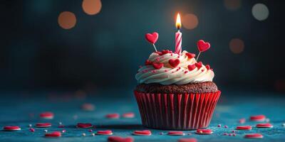 Celebrate with a festive red velvet cupcake topped with hearts and a candle for a special occasion photo