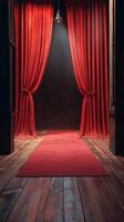Red velvet curtains and a carpet create an inviting atmosphere for a theatrical performance in a dimly lit venue photo