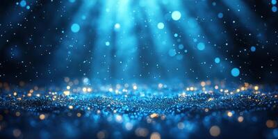 Captivating blue glitter particles illuminated by soft light create a dreamy atmosphere in a dark setting photo