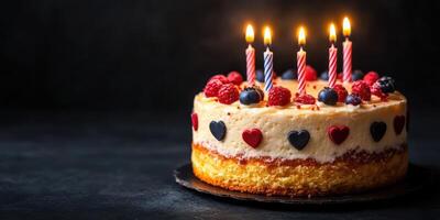Celebration cake with candles, berries, and heart decorations ready for a festive occasion photo