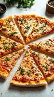 Slices of freshly baked cheese pizza with herbs arranged in a circular pattern on a marble countertop photo