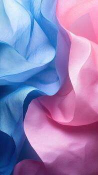 Flowing fabric in shades of blue and pink creates a vibrant and soft texture for artistic backgrounds photo