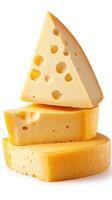Stack of delicious yellow cheese varieties displayed on a clean surface for culinary use and inspiration photo